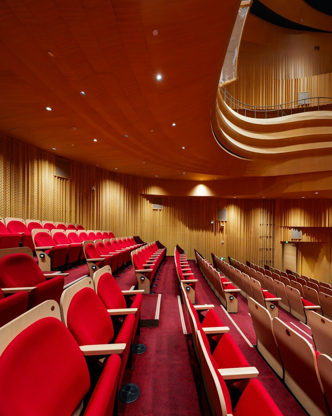 Rows of empty seats inside a muted European theater auditorium